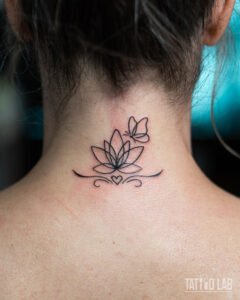 Fine line lotus flower tattoo with a butterfly and small heart flourish on the back of the neck