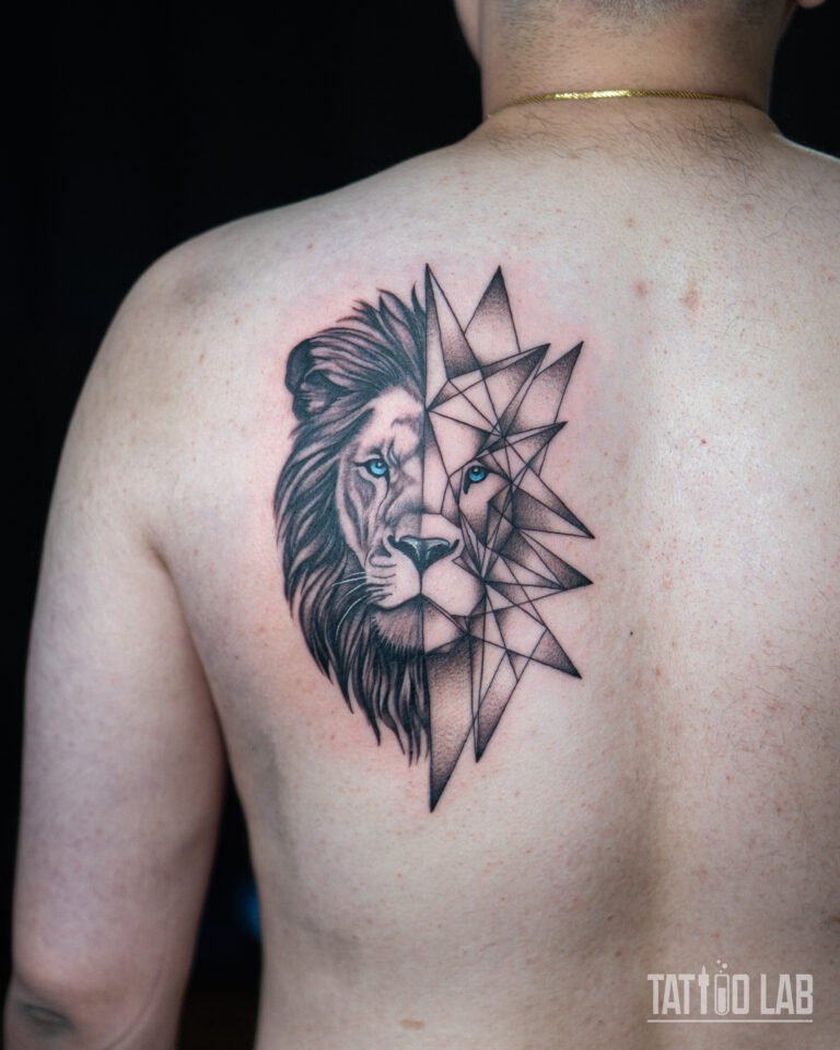 Half realistic, half geometric lion tattoo with blue eyes on the shoulder blade, black and grey