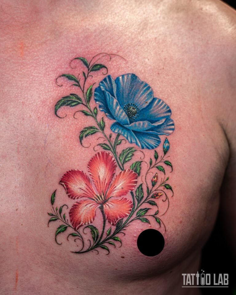 Wide view of a blue poppy and red hibiscus colour realism tattoo on the chest