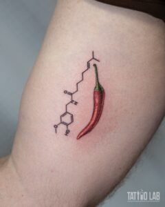 Colour realism red chili pepper tattoo beside a fine line capsaicin molecule diagram on the upper arm