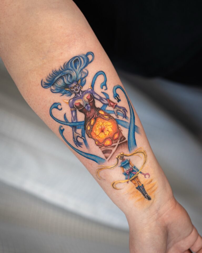 Colour anime tattoo of Sailor Moon beneath a blue-haired villain with serpent tendrils and a glowing core on the forearm