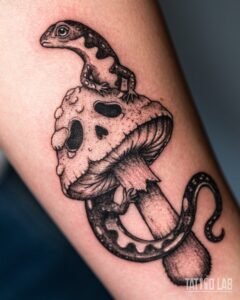 Fine line salamander tattoo climbing a mushroom, with dotwork shading, on the forearm
