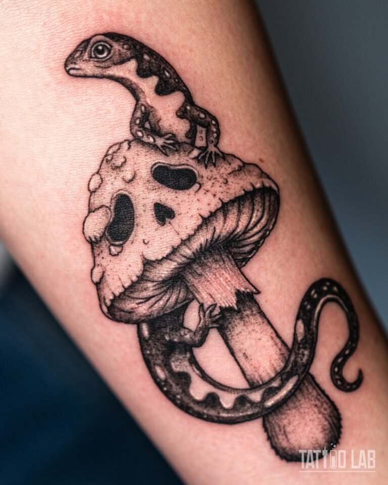 Fine line salamander tattoo climbing a mushroom, with dotwork shading, on the forearm