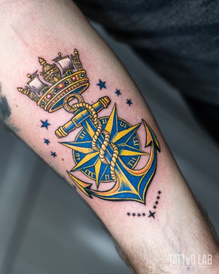 Neo-traditional colour tattoo of a rope-wrapped anchor over a compass star with a naval crown, forearm